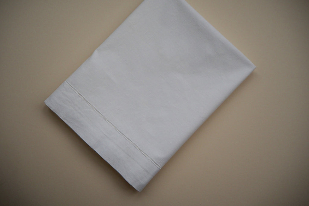 White flat sheet with open-work hand embroidery